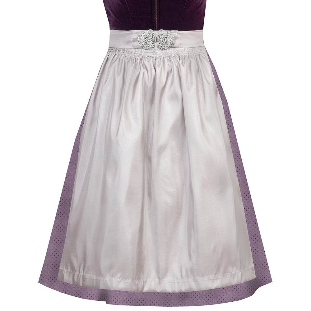 Elegantes Dirndl mit schlichtem Samtmieder in pflaumenfarbe und Reißverschluss mit Herzanhänger. Der Rock ist zart gepunktet, die mauvefarbene Schürze wird durch eine dekorative Schließe ergänzt.