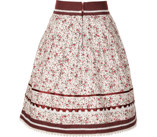 Weißer Rock in A-Linien-Form mit zartem Streublumenmuster, verziert mit drei Borten und einer Spitzenborte am Saum. Am Bund ist ein kleines Schleifchen mit Herzanhänger zu sehen, Reißverschluss hinten mittig.