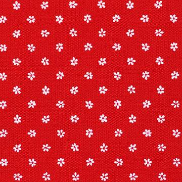 Stoffmuster für Dirndl mit kleinen roten und weißen Blumen auf Oberteilstoff, weiße Schürze mit roten Blümchen und dunkelblauer Rockstoff mit weißem Hirschmuster.