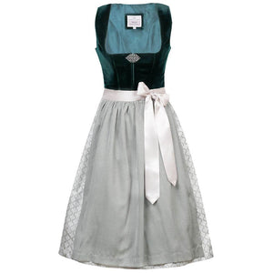 Elegantes Dirndl mit schlichtem Samtmieder in smaragdgrün und Reißverschluss sowie Schließe am Ausschnitt. Der Rock zeigt ein Ornamentenmuster und ist farblich abgestimmt mit der passenden Schürze.