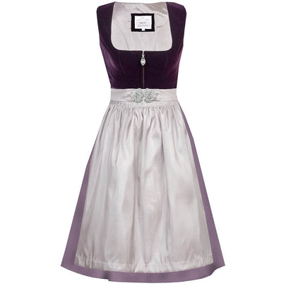 Elegantes Dirndl mit schlichtem Samtmieder in pflaumenfarbe und Reißverschluss mit Herzanhänger. Der Rock ist zart gepunktet, die mauvefarbene Schürze wird durch eine dekorative Schließe ergänzt.