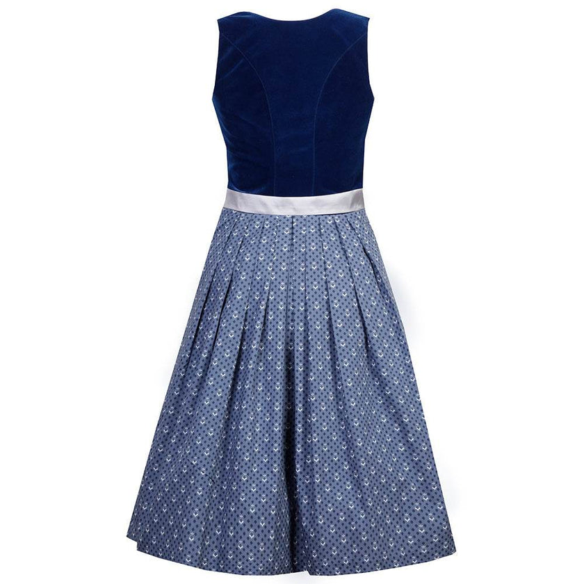 Hochwertiges Dirndl mit schlichtem Samtmieder in saphirblau und Reißverschluss mit Herzanhänger. Der Rock zeigt ein zartes Pünktchenmuster, die silberne Schürze ist mit einer dekorativen Schließe versehen.