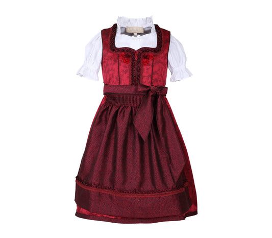 Festliches Kinderdirndl in Rot mit allover Ornamentenmuster, Reißverschluss und Schnürung am Mieder, verspielte kleine Röschen am Oberteil, dazu Spitzenschürze und passende Bluse.